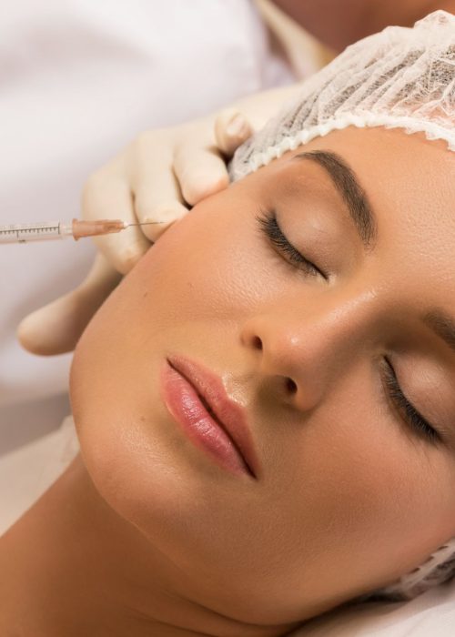 Woman in professional beauty salon during facial injections for rejuvenation
